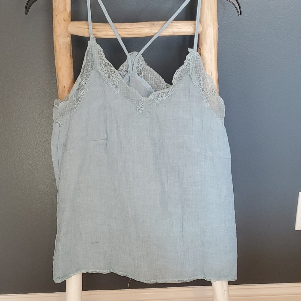 light blue cotton lace-trim camisole top with criss-cross straps. Medium